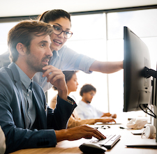 Woman giving advice to colleague on software